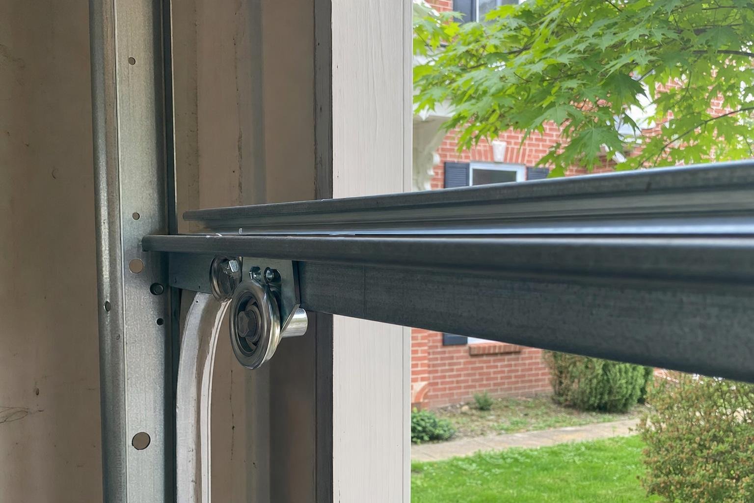 Stock photo of garage door roller replacement work