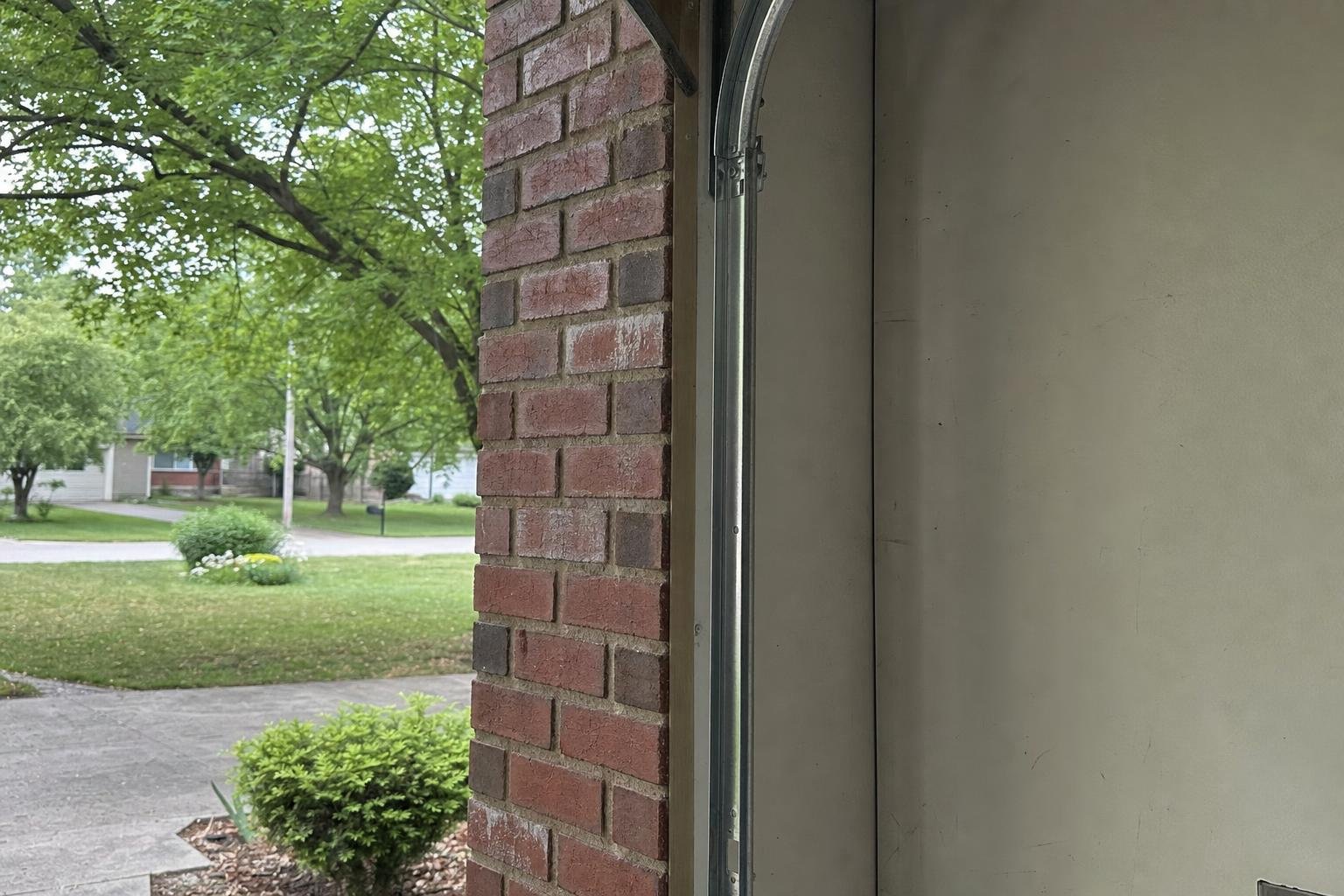 Illustrative image of garage door track realignment and repair work